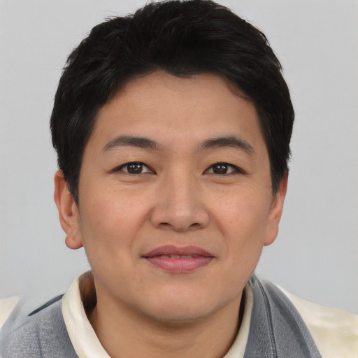 Joyful asian young-adult female with short  brown hair and brown eyes