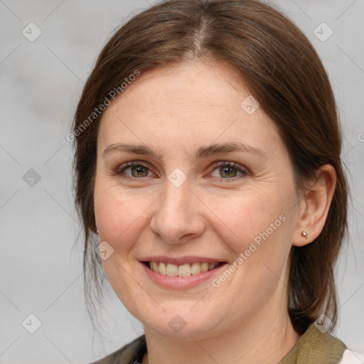 Joyful white adult female with medium  brown hair and brown eyes