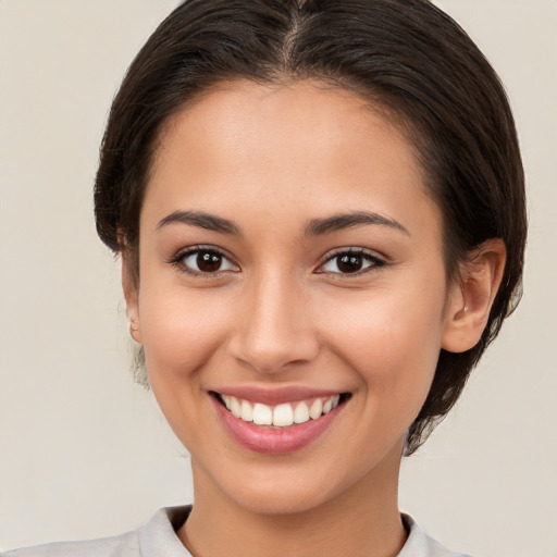 Joyful white young-adult female with medium  brown hair and brown eyes