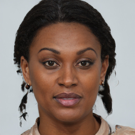 Joyful black adult female with medium  brown hair and brown eyes