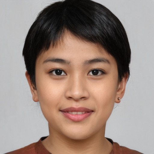 Joyful asian young-adult female with short  brown hair and brown eyes