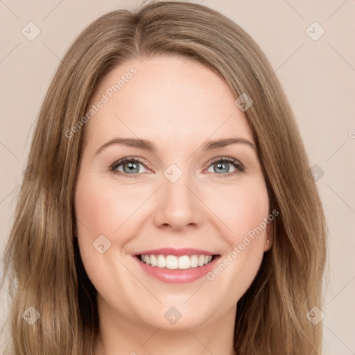 Joyful white young-adult female with long  brown hair and green eyes