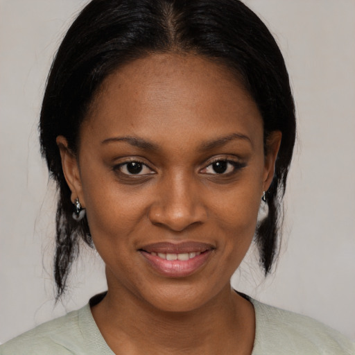 Joyful black young-adult female with medium  brown hair and brown eyes
