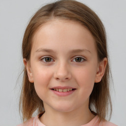 Joyful white child female with medium  brown hair and brown eyes