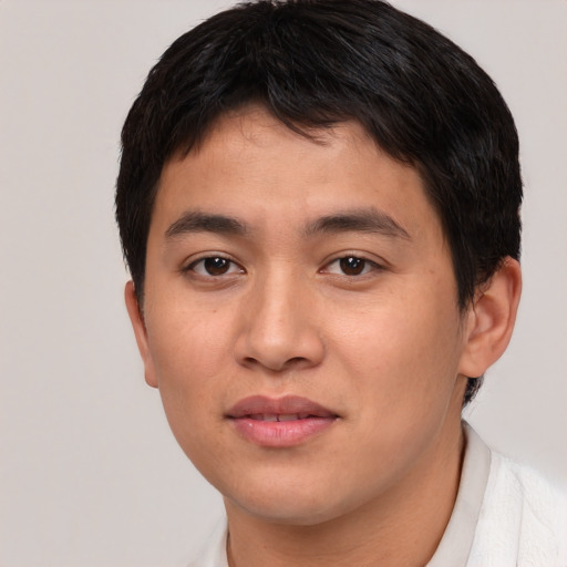 Joyful asian young-adult male with short  brown hair and brown eyes
