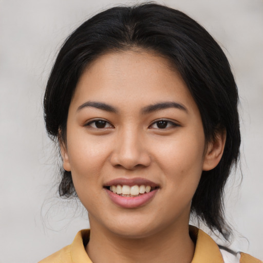 Joyful asian young-adult female with medium  black hair and brown eyes