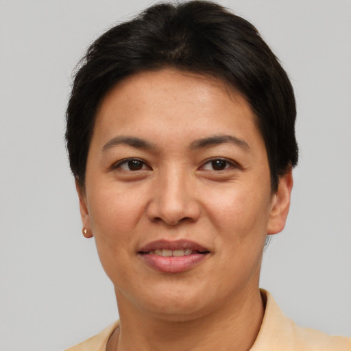 Joyful asian adult female with short  brown hair and brown eyes