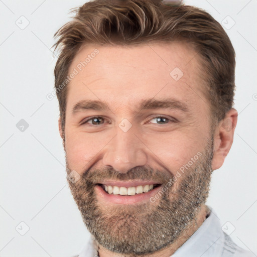 Joyful white adult male with short  brown hair and brown eyes