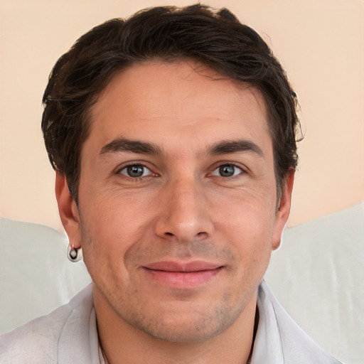 Joyful white adult male with short  brown hair and brown eyes