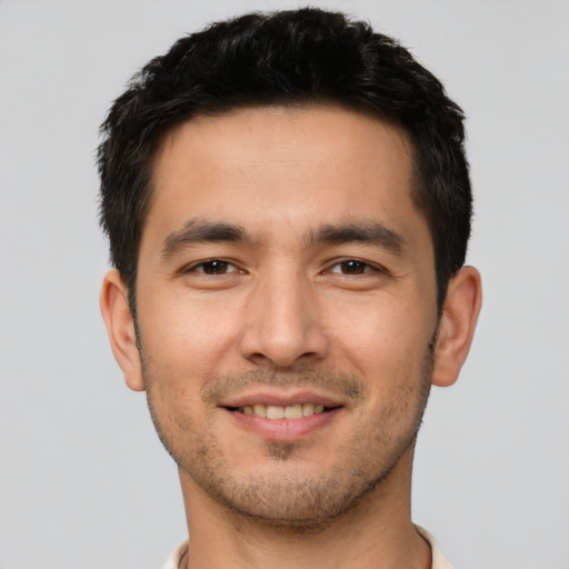 Joyful asian young-adult male with short  brown hair and brown eyes