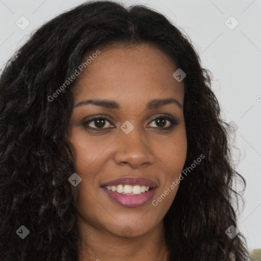 Joyful black young-adult female with long  brown hair and brown eyes