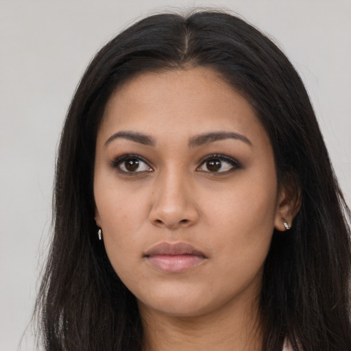 Neutral latino young-adult female with long  brown hair and brown eyes