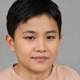 Joyful asian child male with short  brown hair and brown eyes