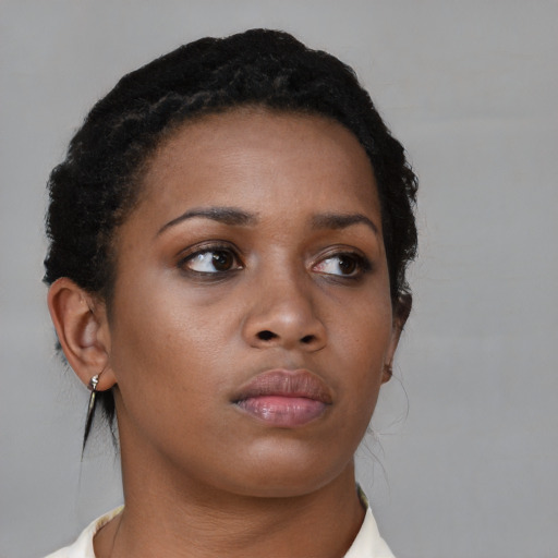 Neutral black young-adult female with medium  brown hair and brown eyes