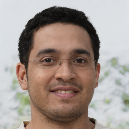 Joyful latino young-adult male with short  brown hair and brown eyes