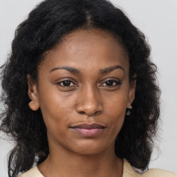 Neutral black young-adult female with medium  brown hair and brown eyes