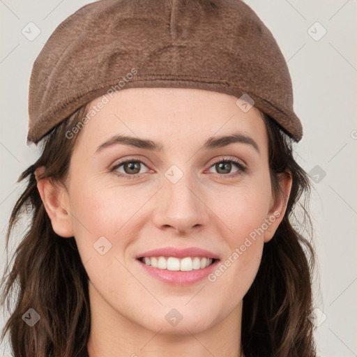 Joyful white young-adult female with long  brown hair and grey eyes