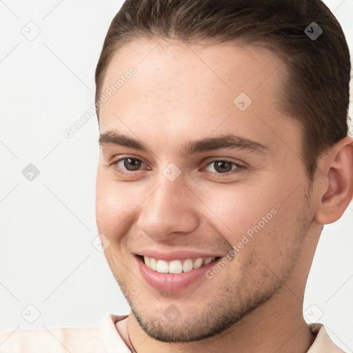 Joyful white young-adult male with short  brown hair and brown eyes