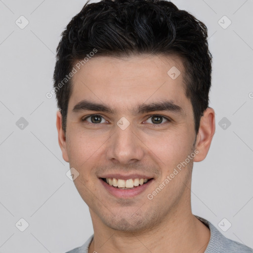 Joyful white young-adult male with short  black hair and brown eyes