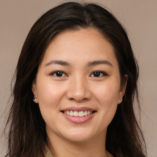 Joyful white young-adult female with long  brown hair and brown eyes