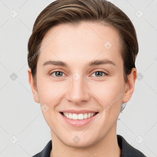 Joyful white young-adult female with short  brown hair and grey eyes