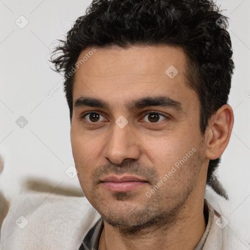 Joyful white young-adult male with short  black hair and brown eyes