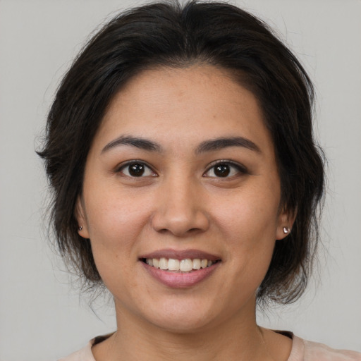 Joyful white young-adult female with medium  brown hair and brown eyes