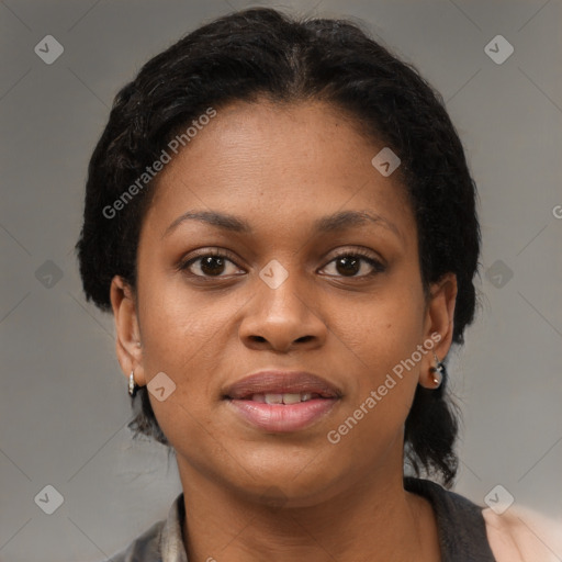 Joyful black young-adult female with short  black hair and brown eyes