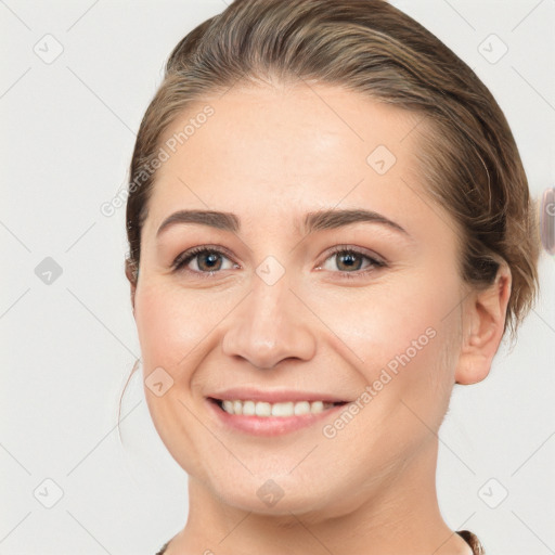 Joyful white young-adult female with medium  brown hair and grey eyes