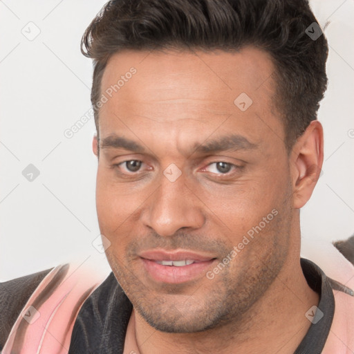 Joyful white adult male with short  brown hair and brown eyes