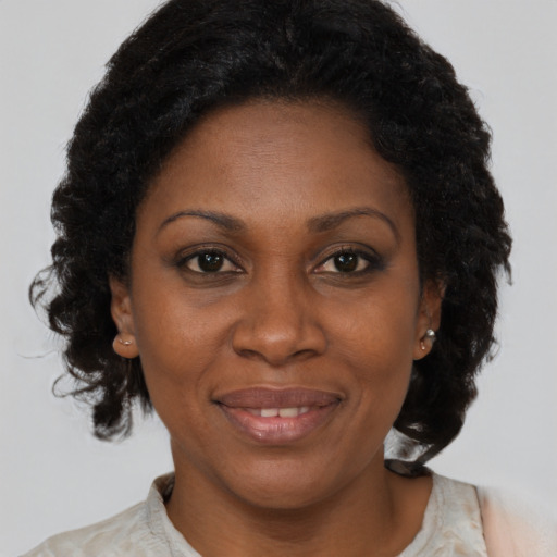 Joyful latino adult female with medium  brown hair and brown eyes