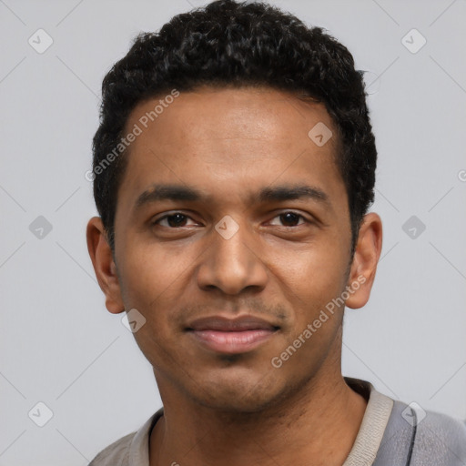 Joyful black young-adult male with short  black hair and brown eyes