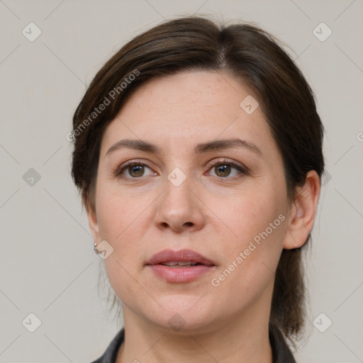 Joyful white adult female with medium  brown hair and grey eyes