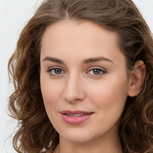 Joyful white young-adult female with long  brown hair and green eyes