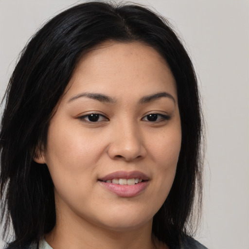 Joyful asian young-adult female with long  brown hair and brown eyes