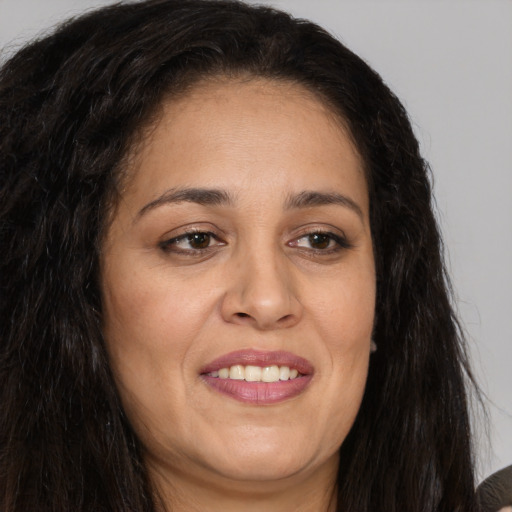 Joyful white adult female with long  brown hair and brown eyes