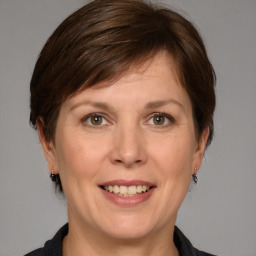 Joyful white adult female with medium  brown hair and grey eyes