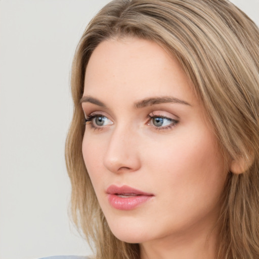 Neutral white young-adult female with long  brown hair and green eyes