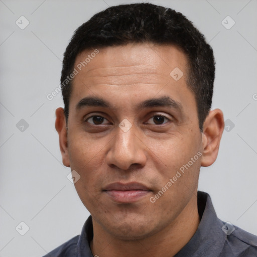 Joyful latino adult male with short  black hair and brown eyes