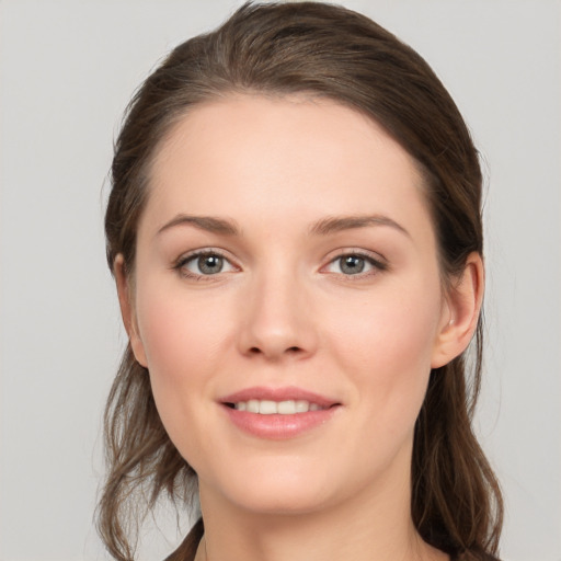 Joyful white young-adult female with long  brown hair and grey eyes