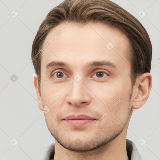 Joyful white young-adult male with short  brown hair and grey eyes