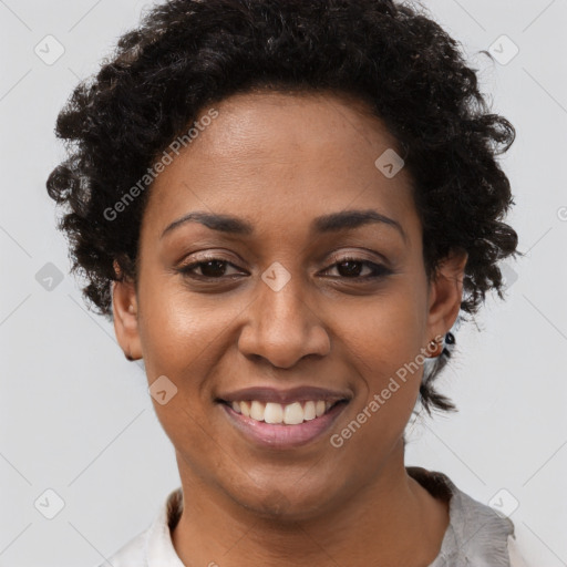 Joyful black young-adult female with short  brown hair and brown eyes