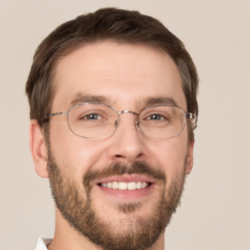 Joyful white adult male with short  brown hair and green eyes