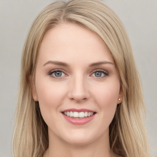 Joyful white young-adult female with long  brown hair and grey eyes