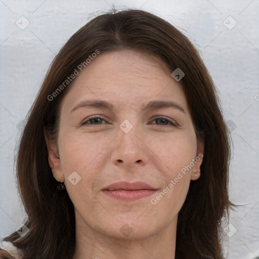 Joyful white adult female with long  brown hair and brown eyes