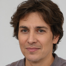 Joyful white adult male with medium  brown hair and brown eyes