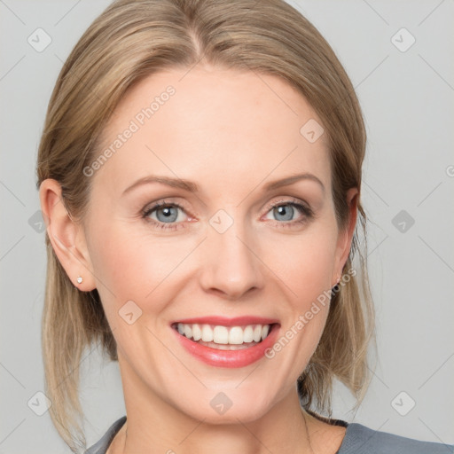 Joyful white young-adult female with medium  brown hair and blue eyes