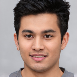 Joyful asian young-adult male with short  brown hair and brown eyes