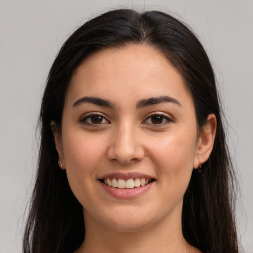 Joyful white young-adult female with long  brown hair and brown eyes