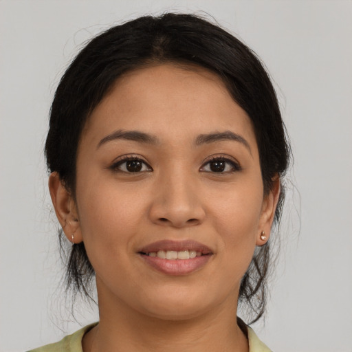 Joyful latino young-adult female with medium  brown hair and brown eyes